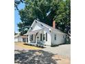 Charming renovated home with a welcoming front porch and tidy landscaping features at 229 W Gray Ave, Mooresville, NC 28115