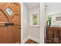 Charming entry foyer featuring a unique wooden door and diamond lattice window at 2304 Commonwealth Ave, Charlotte, NC 28205