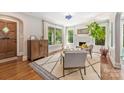 Bright living room with large windows, hardwood floors, fireplace, and stylish decor at 2304 Commonwealth Ave, Charlotte, NC 28205