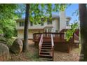 A backyard view showcases the home's large deck and ample green space with mature trees at 3104 Highgate Dr, Fort Mill, SC 29715