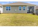Well-maintained backyard with a level lawn, screen door, and ample space for outdoor activities at 329 Secretariat Dr, Iron Station, NC 28080
