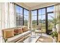 Bright sunroom with large windows, comfortable seating, and peaceful backyard views at 329 Secretariat Dr, Iron Station, NC 28080