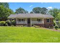 Charming home boasting a well-manicured lawn, brick accents, and a inviting front porch perfect for relaxation at 3712 Eaglebrook Dr, Gastonia, NC 28056