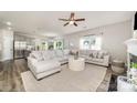 Open-concept living room boasts ample seating and views of the kitchen, great for entertaining at 4009 Stoneygreen Ln, Charlotte, NC 28215