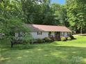 Charming home exterior features a porch, well-kept lawn, and landscaped garden at 4225 Stewart Rd, Claremont, NC 28610