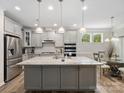 Modern kitchen features granite countertops, stainless steel appliances, and a large center island at 4316 Falls Lake Sw Dr, Concord, NC 28025