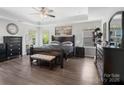 Spacious main bedroom with tray ceilings, lots of natural light, and wood floors at 4316 Falls Lake Sw Dr, Concord, NC 28025