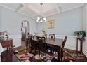 Dining room with coffered ceiling, modern chandelier, large window, table with seating for six at 5384 Gatsby Cir, Rock Hill, SC 29732