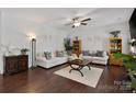 Spacious living room with hardwood floors, neutral furniture, ceiling fan, and decorative shelves at 5384 Gatsby Cir, Rock Hill, SC 29732
