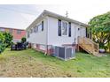 View of the home's backyard featuring a patio set, brick foundation and A/C unit at 55 Ranlo Ave, Gastonia, NC 28054