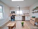 Bright kitchen featuring white cabinets, butcher block countertops, and stainless appliances at 55 Ranlo Ave, Gastonia, NC 28054