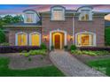 Charming brick home featuring a welcoming front entrance and manicured landscaping at 5701 Challisford Ln, Charlotte, NC 28226