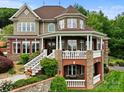 Gorgeous home with brick and stone exterior, detailed trim, a covered porch and immaculate landscaping at 6164 Dwayne Starnes Dr, Hickory, NC 28602