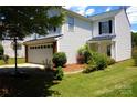 Charming two-story home with a well-kept lawn, featuring an attached garage and inviting front porch at 6614 Wicked Oak Ln, Charlotte, NC 28216