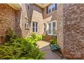 Inviting brick home entrance with mature ferns and manicured landscaping at 7365 Gabriel St, Sherrills Ford, NC 28673