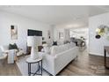 Staged living room filled with neutral furniture and decor, with dining area visible in the background at 8118 Jacey Ln # 21, Huntersville, NC 28078