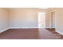 Bright living room with neutral walls, carpet flooring, and ample natural light at 819 W Rankin Ave, Gastonia, NC 28052