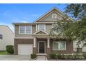 Charming two-story home featuring brick and siding, a front porch, and an attached garage at 838 Von Buren Blvd, Rock Hill, SC 29730