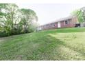 Large backyard with lush lawn and shade trees, perfect for outdoor activities and relaxation at 856 Skyline Dr, Chester, SC 29706