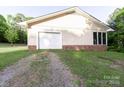 Attached garage with white door and adjacent windows, offering convenient parking and storage at 856 Skyline Dr, Chester, SC 29706