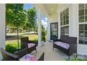 Relaxing covered front porch featuring comfortable seating and lovely views of the neighborhood at 9003 Smokey Hill Ln, Fort Mill, SC 29707