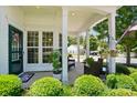 Inviting front porch with seating area, hanging flower baskets, and view of the well-maintained front yard at 9003 Smokey Hill Ln, Fort Mill, SC 29707