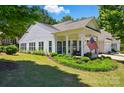 Beautiful curb appeal of a home featuring a cozy front porch with an American flag and lush green lawn at 9003 Smokey Hill Ln, Fort Mill, SC 29707