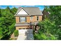 Aerial view of brick home, showcasing the roof, yard and surrounding trees in a well-established neighborhood at 9735 Wheatfield Rd, Charlotte, NC 28277