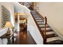 Elegant foyer featuring hardwood floors, a staircase with ornate railings, and neutral paint colors at 9735 Wheatfield Rd, Charlotte, NC 28277