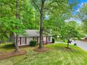 Quaint home with mature landscaping, showcasing a well-maintained lawn and verdant trees at 10200 Cairnsmore Pl # 9, Mint Hill, NC 28227
