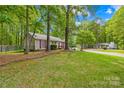 A lovely home in a wooded neighborhood features a lush green lawn and mature trees at 10200 Cairnsmore Pl # 9, Mint Hill, NC 28227