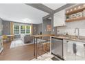 Stylish kitchen featuring stainless steel appliances, a breakfast bar, and open access to the living area at 1100 Mona Dr, Charlotte, NC 28206