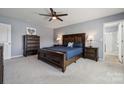 The main bedroom features a ceiling fan, carpet, and an ensuite bathroom with a glass shower at 1180 Bannockburn Ave, Rock Hill, SC 29732