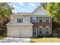 Charming two-story home with brick and siding, complemented by a manicured lawn and a two-car garage at 11807 Hawick Valley Ln, Charlotte, NC 28277