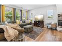Bright living room with large windows, comfortable seating, and modern decor at 119 Berkeley Ave # A, Mooresville, NC 28117