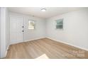 Bright bedroom featuring new floors, crisp white walls, and natural light streaming through the windows at 1211 N Boyce St, Gastonia, NC 28052