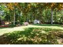 Expansive backyard with mature trees, green lawn, and storage shed at 1261 Hawthorne Dr, Indian Trail, NC 28079