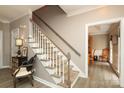 Elegant staircase with carpeted steps and white railings leading to the upper level at 1261 Hawthorne Dr, Indian Trail, NC 28079