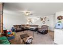 Inviting living room with a comfortable sectional sofa and ceiling fan, creating a relaxed atmosphere for gatherings at 1270 Winding Creek Rd, Salisbury, NC 28146