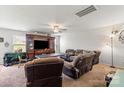 Cozy living room featuring plush seating, a ceiling fan, and a built-in entertainment center at 1270 Winding Creek Rd, Salisbury, NC 28146