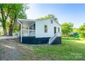 View of the back of the house with access steps to the covered porch, with newly installed grass at 1411 Caldwell St, Gastonia, NC 28052