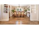 Traditional dining room featuring wood floors, chandelier, and decorative fireplace at 145 Driftwood Dr, Mooresville, NC 28117