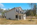 Side view of a two-story home showcasing gray siding and well-maintained landscaping at 1837 Bear St, Charlotte, NC 28214