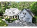 Spacious home featuring a covered front porch, two-car garage and lush landscaping at 1956 Forest Ridge Dr, Stanley, NC 28164