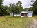 A quaint single-story home with blue siding, a front porch, and a spacious yard at 2131 Barnett St, Lancaster, SC 29720