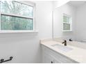 Bathroom featuring a white vanity with a quartz countertop, a mirror, and a window at 2815 New Pineola Rd, Charlotte, NC 28208