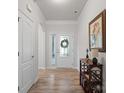 Bright entryway showcasing wood floors, a decorative table, and a glass-paneled front door at 3103 Oliver Stanley Trl, Lancaster, SC 29720