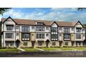 Modern townhome exterior showcasing multi-tone brick, vertical siding and inviting entryways at 3128 Stelfox St, Charlotte, NC 28262