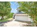 Beautifully landscaped home exterior featuring a two-car garage and lush greenery at 4002 Solomons Ct, Monroe, NC 28110