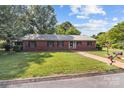 Quaint brick home featuring a brick pathway, well-kept lawn, and decorative mailbox, radiating curb appeal at 402 School St, Rockwell, NC 28138